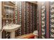 Charming half bathroom with a pedestal sink, toilet, and unique wallpaper at 14030 Old Mill Ct, Carmel, IN 46032