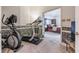A compact home gym features a treadmill and elliptical machine conveniently located off the main bedroom at 14030 Old Mill Ct, Carmel, IN 46032