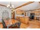 Sunlit eat-in kitchen and dining area with light wood flooring and chandelier at 14030 Old Mill Ct, Carmel, IN 46032