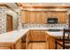 Traditional kitchen featuring wood cabinets, white countertops and modern appliances at 14030 Old Mill Ct, Carmel, IN 46032