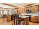 Spacious eat-in kitchen featuring hardwood floors, island, white countertops and modern appliances at 14030 Old Mill Ct, Carmel, IN 46032