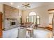 Cozy living room with a brick fireplace, large arched window, and comfortable furniture at 14030 Old Mill Ct, Carmel, IN 46032