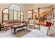 Bright living room with large arched window, comfortable seating, and an open layout at 14030 Old Mill Ct, Carmel, IN 46032