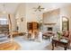 Bright living room with vaulted ceilings, brick fireplace, and comfortable seating arrangement at 14030 Old Mill Ct, Carmel, IN 46032