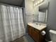 Bathroom featuring a vanity with a light countertop and a shower-tub combo at 1406 Bigleaf Cir, Sheridan, IN 46069