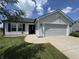 Charming home with a two-car garage, landscaped yard, and a welcoming front entrance at 1406 Bigleaf Cir, Sheridan, IN 46069