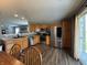 Modern kitchen featuring stainless steel appliances, wooden cabinetry, and a gray backsplash at 1406 Bigleaf Cir, Sheridan, IN 46069