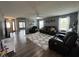 Inviting living room with gray walls, wood flooring, comfortable seating and a ceiling fan at 1406 Bigleaf Cir, Sheridan, IN 46069