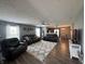 Cozy living room with ample seating, warm lighting, and seamless flow to the dining area at 1406 Bigleaf Cir, Sheridan, IN 46069