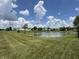Scenic view of community pond surrounded by lush greenery and well-maintained lawns at 1406 Bigleaf Cir, Sheridan, IN 46069
