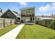 Spacious backyard showcases a patio, hot tub, verdant lawn, and contemporary home design at 1406 Linden St, Indianapolis, IN 46203