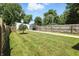 Lush backyard with a garden shed, mature trees, and a well-manicured lawn at 1406 Linden St, Indianapolis, IN 46203