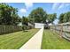 Expansive backyard with lush green grass, a garden shed, and a charming pathway at 1406 Linden St, Indianapolis, IN 46203