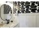 Stylish bathroom featuring a black and white color scheme and oval mirror above the marble vanity at 1406 Linden St, Indianapolis, IN 46203