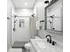 Modern bathroom featuring matte black fixtures, including a rainfall shower head and tiled walk-in shower at 1406 Linden St, Indianapolis, IN 46203