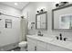 Bright bathroom featuring double sinks with marble countertop and matte black fixtures, plus tiled walk-in shower at 1406 Linden St, Indianapolis, IN 46203