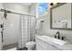 Updated bathroom featuring elegant vanity, shower, and natural lighting at 1406 Linden St, Indianapolis, IN 46203