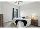 Cozy bedroom with large bed, bedside tables with lamps, and a ceiling fan at 1406 Linden St, Indianapolis, IN 46203