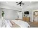 Bedroom with ensuite bathroom, ceiling fan, and dresser at 1406 Linden St, Indianapolis, IN 46203