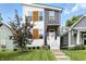 Striking two-story home boasting a modern facade, manicured lawn, and inviting front steps at 1406 Linden St, Indianapolis, IN 46203