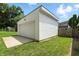 Detached garage with concrete driveway on a grassy lot at 1406 Linden St, Indianapolis, IN 46203