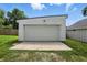 A detached one-car garage with white siding sits on a concrete pad with a grassy lawn at 1406 Linden St, Indianapolis, IN 46203