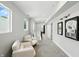 Upstairs hallway with comfortable seating, natural light, and decorative artwork at 1406 Linden St, Indianapolis, IN 46203