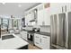Modern kitchen offers stainless appliances, white cabinets, dark counters and an open layout to living room at 1406 Linden St, Indianapolis, IN 46203