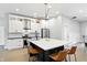 Bright kitchen features stainless steel appliances, white cabinets, a waterfall island and sleek modern lighting at 1406 Linden St, Indianapolis, IN 46203