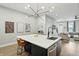 Open kitchen layout provides island seating and stainless appliances, leading to the living room at 1406 Linden St, Indianapolis, IN 46203