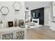 An open concept view into the living room featuring a fireplace, modern shelving and hardwood floors at 1406 Linden St, Indianapolis, IN 46203