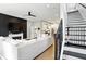 Open-concept living room with fireplace, modern kitchen, and staircase, perfect for entertaining at 1406 Linden St, Indianapolis, IN 46203