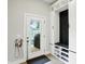 Bright mudroom with storage bench, shoe cubbies, and an exterior door leading to the backyard at 1406 Linden St, Indianapolis, IN 46203