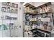Organized walk-in pantry with wooden shelving, wire baskets, and an assortment of food items at 1406 Linden St, Indianapolis, IN 46203