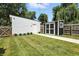 The backyard features a white garden shed and black storage shed with manicured landscaping at 1406 Linden St, Indianapolis, IN 46203