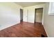 This is a bedroom with wood-look floors, light walls, a window and a closet at 1509 S Rural St, Indianapolis, IN 46203