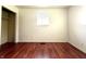 Bright room with wood-look floors and neutral walls, a closet and a window at 1509 S Rural St, Indianapolis, IN 46203