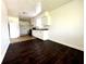 Well-lit kitchen with white cabinets, modern appliances, and two-toned flooring at 1509 S Rural St, Indianapolis, IN 46203