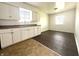 Well-lit kitchen with white cabinets, modern appliances, and two-toned flooring at 1509 S Rural St, Indianapolis, IN 46203