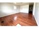Spacious living room with gleaming hardwood floors, neutral wall color, and ample natural light at 1509 S Rural St, Indianapolis, IN 46203