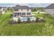 Aerial view of a spacious backyard featuring a pool, patio, and lush green lawn, perfect for outdoor entertaining at 16283 Spring Bank Ct, Fishers, IN 46040