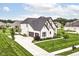 Aerial view of a two-story home with a manicured lawn and long driveway at 16283 Spring Bank Ct, Fishers, IN 46040