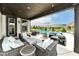 Outdoor patio with wicker furniture, egg smoker, a ceiling, and a stunning view of the pool and backyard at 16283 Spring Bank Ct, Fishers, IN 46040