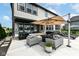 A beautiful backyard with an outdoor kitchen, lounging area, and a large patio, all surrounding a backyard pool at 16283 Spring Bank Ct, Fishers, IN 46040