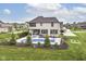 Gorgeous home featuring a backyard pool, a patio lounge area, and a beautifully landscaped yard at 16283 Spring Bank Ct, Fishers, IN 46040