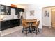 Basement bar with stylish cabinets, stainless steel refrigerator, table, and seating at 16283 Spring Bank Ct, Fishers, IN 46040