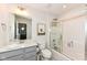 Bright bathroom features a shower and tub combination, a sink with granite countertops, and a whimsical wall print at 16283 Spring Bank Ct, Fishers, IN 46040