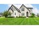 Stunning two-story home featuring a manicured lawn, black trim, and a welcoming entrance at 16283 Spring Bank Ct, Fishers, IN 46040