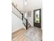 Inviting foyer featuring a staircase, hardwood floors, and a decorative rug at 16283 Spring Bank Ct, Fishers, IN 46040