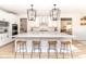 Bright kitchen featuring a large center island, barstool seating, and stainless steel appliances at 16283 Spring Bank Ct, Fishers, IN 46040